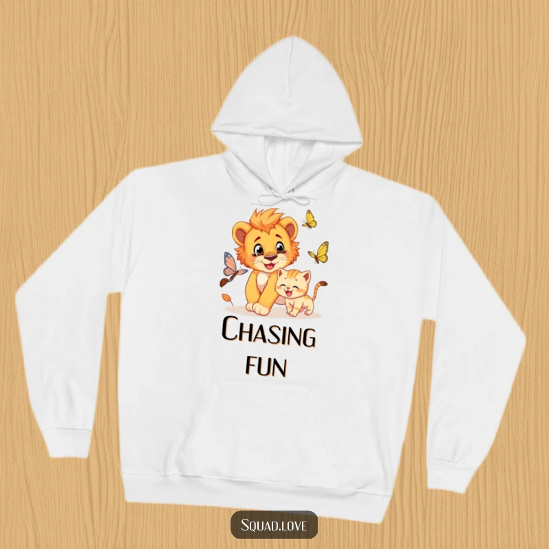 Funny hoodie design of a playful lion cub chasing a butterfly, accompanied by a grinning kitten.