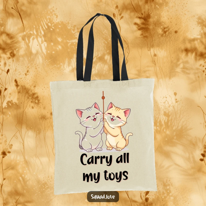 Funny tote bag featuring two cats playfully batting at a string, perfect for carrying essentials with a smile.