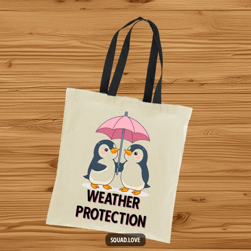 Funny penguin umbrella tote bag, illustration of two playful penguins giggling while sharing an umbrella, perfect for carrying items.